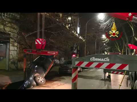 Vehicles removed after sinkhole swallows car on street in Rome