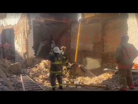 LIVE: Worker trapped after row house collapses