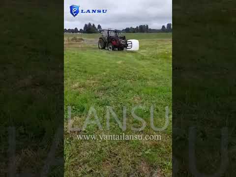 Tractor with hay clip working on farm