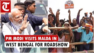 PM Modi visits Malda in West Bengal for roadshow ahead of the Lok Sabha election, waves at the crowd