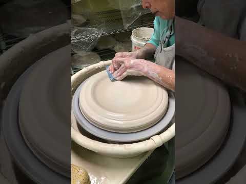 Wheel throwing a large pottery platter