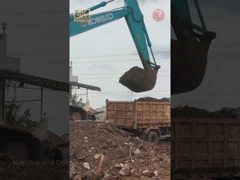 Excavator Loads a lot of Debris into the Truck