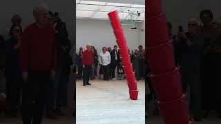 Artist Roman Signer activates his sand bucket sculpture at Malmö Konsthall