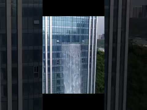 A skyscraper with a waterfall in China