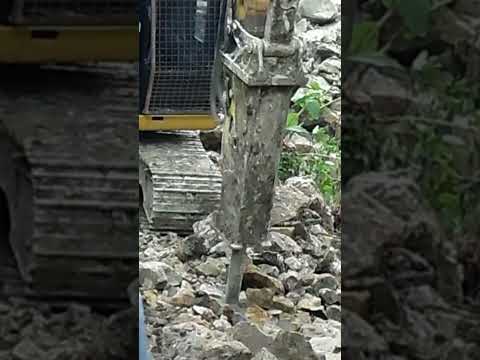 caterpillar Breaker Breaking Limestone for new Road construction