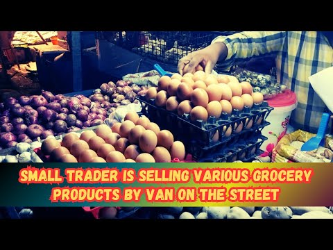 A small trader is selling various grocery products by Van on the street