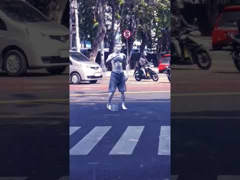 Street performer in the middle of a busy and hot Jakarta traffic intersection 😮