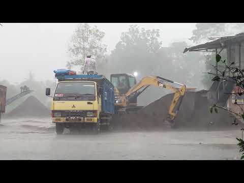 CATERPILLAR 305 MINI EXCAVATOR LOADING MITSUBISHI CANTER RAGASA IN HEAVY RAIN