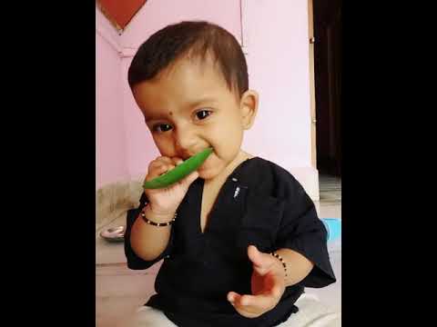 baby eating  green mango