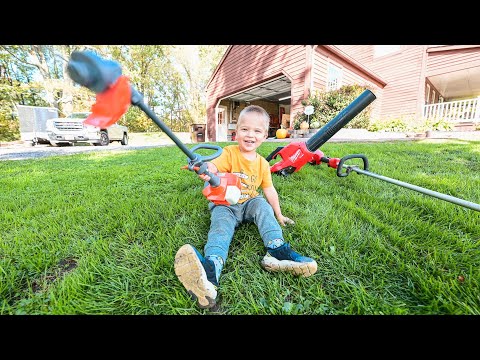 helping dad in the yard. Toy kids weed eater and real one