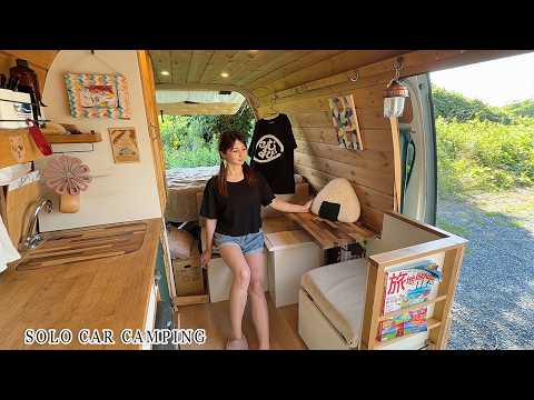 A woman travels in a homemade van, relaxing in nature and enjoying the summer (carcamping)