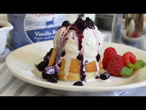 Mini almond butter cakes, served warm with a scoop of ice cream and a drizzle of warm berry compote