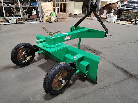 tractor grader blade with tail wheels assembly